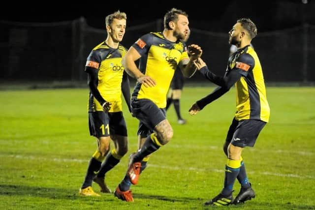Steve Hutchings (middle) celebrates his opening goal at Alresford last night. Picture: Dave Bodymore.