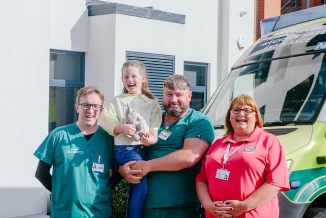 Everlynn Hunt, eight, with workers from PICU