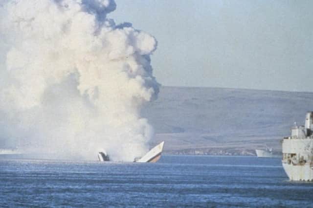 HMS Antelope pictured sinking after a bomb detonated inside her.
