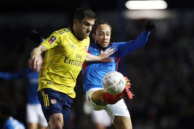 Marcus Harness successfully battles for possession with Arsenal's Sokratis Papastathopoulos in last night's 2-0 FA Cup defeat. Picture: Joe Pepler