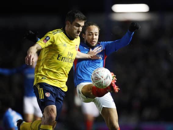 Marcus Harness successfully battles for possession with Arsenal's Sokratis Papastathopoulos in last night's 2-0 FA Cup defeat. Picture: Joe Pepler