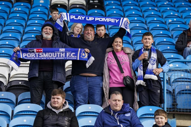 Made it! These Pompey fans look happy after finally arriving at Brunton Park after an early start.