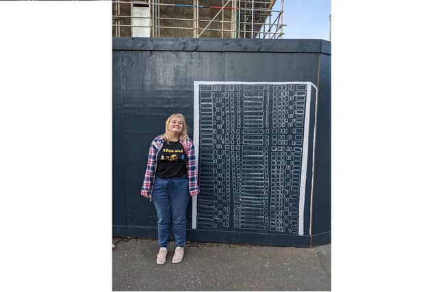 Artist Skyla Swan with the start of her mural outside Horatia House