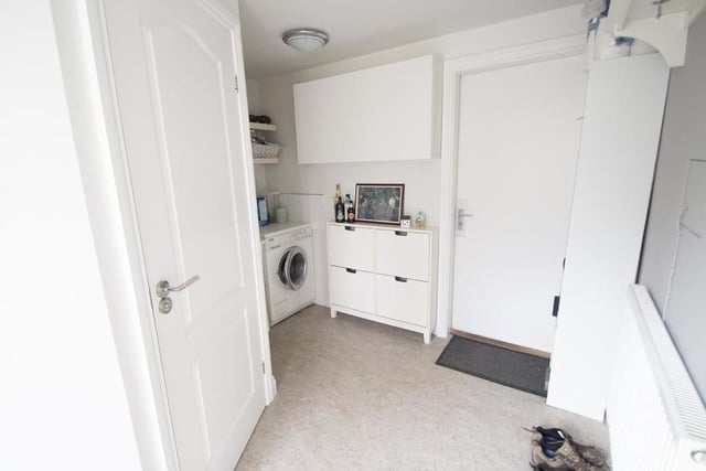 The utility room provides useful storage space.