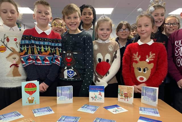 Thousands of cards flooded in to a festive appeal from Asda stores. Pictured: Gomer Junior School pupils with their kind cards
