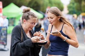 Pictured: Emma and Maisie trying food from cookhouse stall