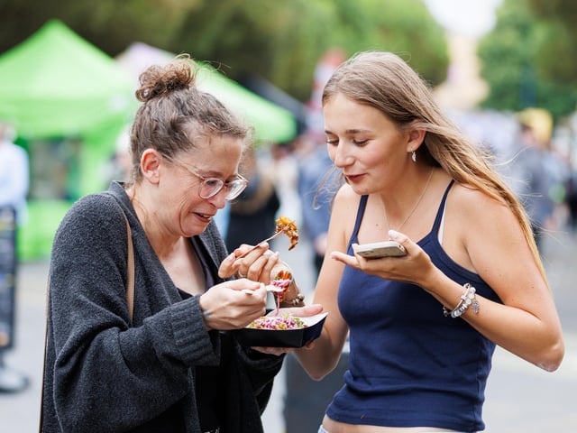 Pictured: Emma and Maisie trying food from cookhouse stall