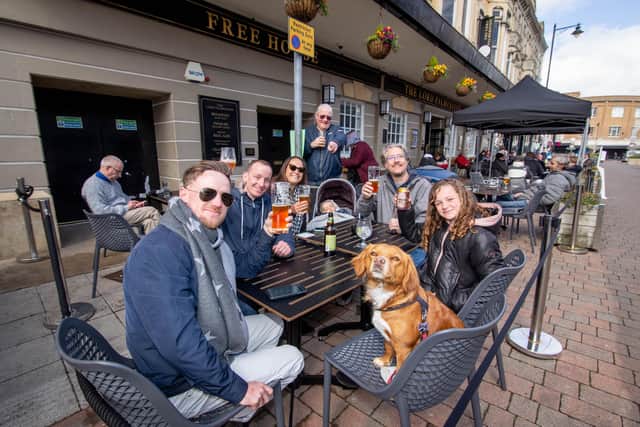 Jerome Matthews, Jasmine the dog, Derek Smith, Selma Matthews, two-year-old Kaylan, Alister English and Sienna Matthews, 11 outside The Lord Palmerston, Palmerston road, Southsea 
Picture: Habibur Rahman