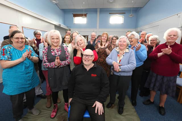 Andy Tolhurst, sitting, has had his head shaved by Rachel Moyce in aid of a planned kitchen refurbishment at Hart Plain Church, Cowplain. Here fellow parishoners show their appreciation
Picture: Chris Moorhouse (jpns 290122-07)