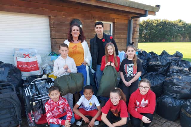 Medina Primary School with donations to send to Ukraine.Pictured left to right: Ronnie Gladman, Charley Francis, Dmitry Kukuruza, Emily Horn, Lexie Hobbs, Oliver Hamilton, Lenux Assicome, Lila Pitman and Delia Dumitiu
