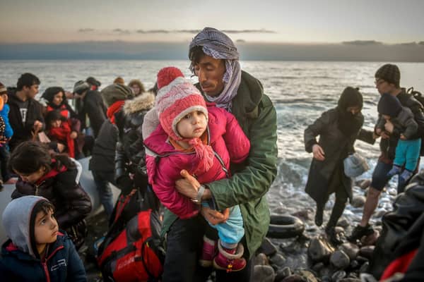 Refugees reach the Greek island of Lesbos after crossing on a dinghy the Aegean sea from Turkey. Picture: Shutterstock