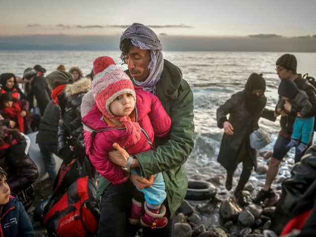 Refugees reach the Greek island of Lesbos after crossing on a dinghy the Aegean sea from Turkey. Picture: Shutterstock