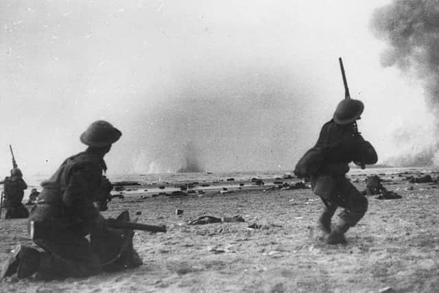 British soldiers fight a rearguard action during the evacuation at Dunkirk, shooting rifles at attacking aircraft (Photo: Grierson/Getty Images)