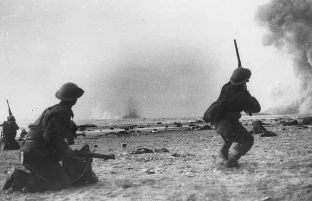 British soldiers fight a rearguard action during the evacuation at Dunkirk, shooting rifles at attacking aircraft (Photo: Grierson/Getty Images)