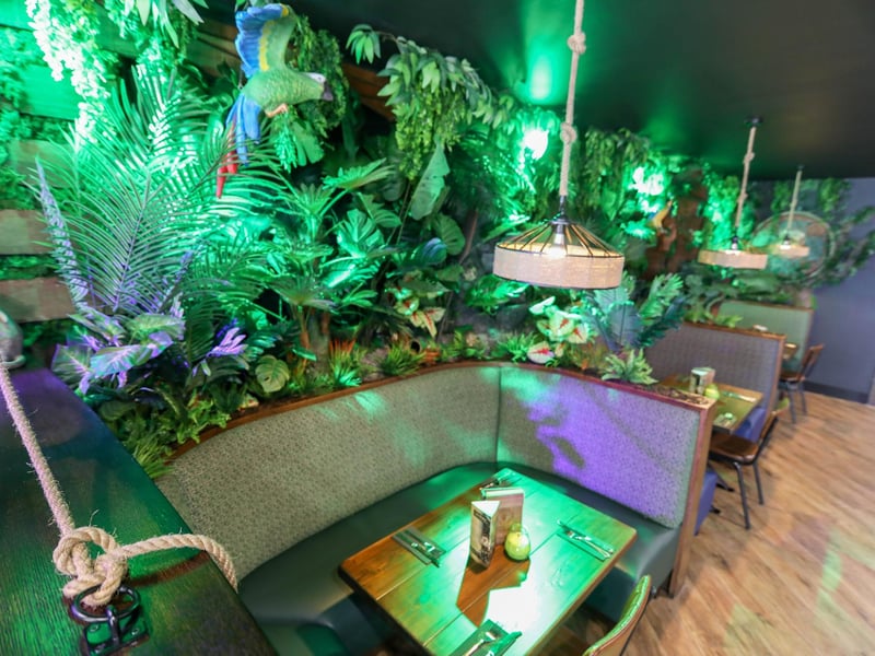 A selection of booths are available for a more private dining experience amongst tropical ferns.