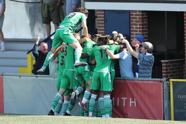 Oxford's Harvey Bradbury celebrates with team-mates and fans after opening the scoring. Picture by Dave Haines.