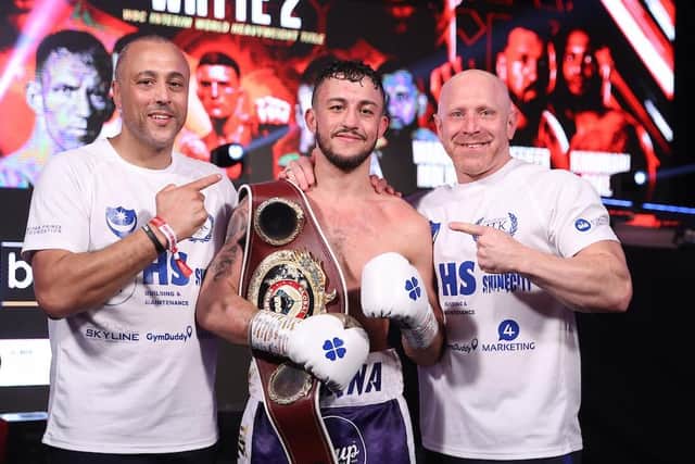 Mikey McKinson, centre, with his WBO Global title with father and trainer Michael Ballingall, left, and Gavin Jones. Picture: Mark Robinson/Matchroom Boxing