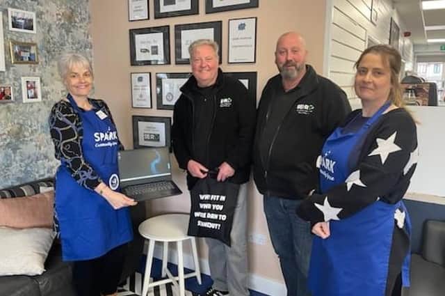 From left - Becki Simmons, founder of Spark Community Space with Gary Dalton and David Edwards from Southern Electrical Recycling, who donated laptops to the charity, and Jenny Cunnington, one of the Spark volunteers.