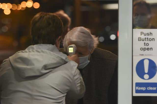 Michael Tibbs, 99, getting his temperature checked as he enters Queen Alexandra Hospital to get his Covid vaccine.

© Ewan Galvin/Solent News & Photo Agency