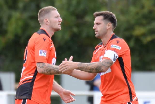 Lee Wort, left, is congratulated by skipper Steve Ramsey after scoring Portchester's third goal against Bemerton. Pic: Martyn White.