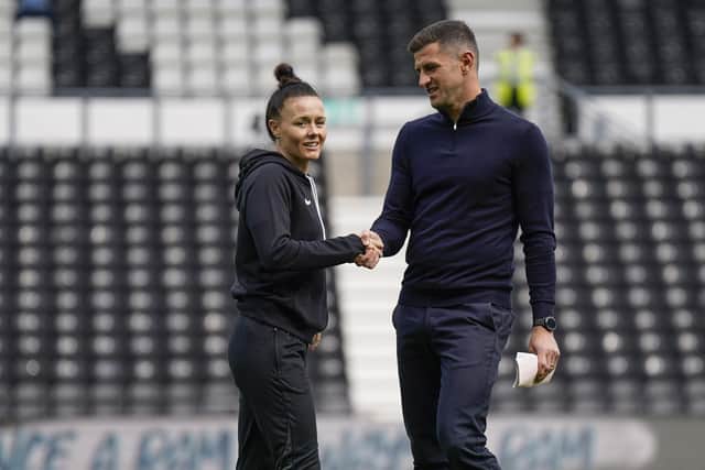 Pompey head coach John Mousinho chats with match referee Rebecca Welch ahead of kick-off at Pride Park