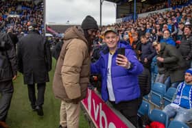 Linvoy Primus poses for a photograph with a fan as part of Pompey's Former Players' Day to mark their 125th Anniversary. Picture: Habibur Rahman