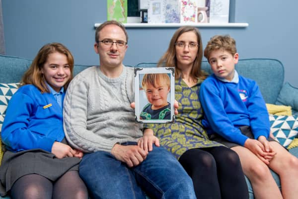 Tribute to Zach Keay who died unexpectedly before Christmas. Now the family is raising funds for Portsmouth Down Syndrome Association

Pictured:Freya 10, Vince and Caroline Keay and Matthew 8 at their home in Swanmore with a picture of Zach on Tuesday 18th January 2022

Picture: Habibur Rahman