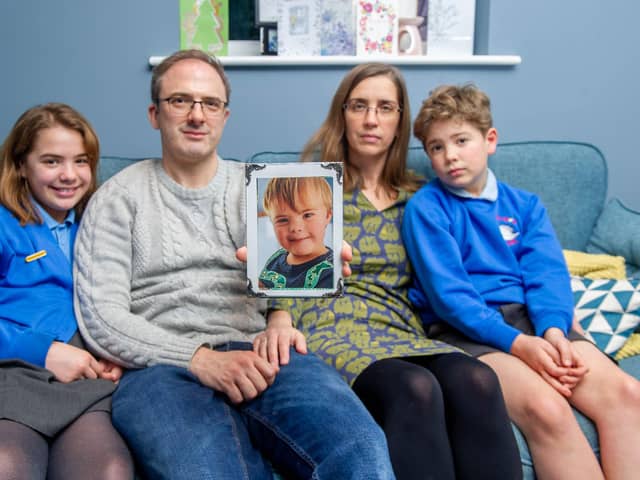 Tribute to Zach Keay who died unexpectedly before Christmas. Now the family is raising funds for Portsmouth Down Syndrome Association

Pictured:Freya 10, Vince and Caroline Keay and Matthew 8 at their home in Swanmore with a picture of Zach on Tuesday 18th January 2022

Picture: Habibur Rahman