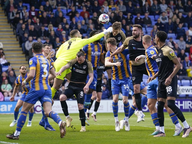 Sean Raggett attempts to connect with a cross into the Shrewsbury penalty area.