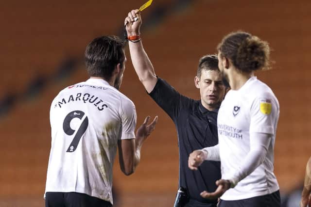 Pompey's John Marquis is shown a yellow card and is booked by referee Josh Smith at Blackpool. Picture: Daniel Chesterton/PinPep