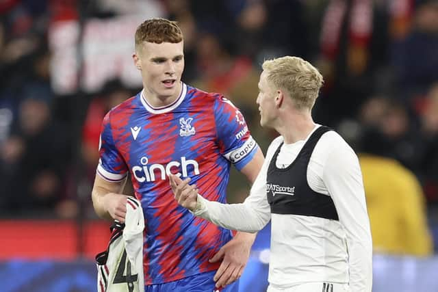 Jake O'Brien with Manchester United's Donny van de Beek (Photo by MARTIN KEEP/AFP via Getty Images).