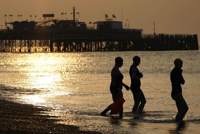 Swimmers make their way into the sea off of Southsea beach. Picture: Andrew Matthews/PA Wire