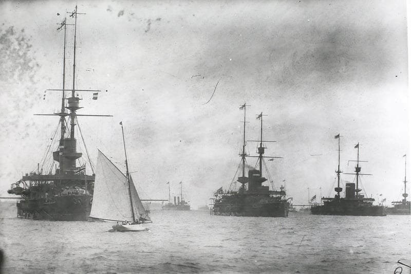 Royal Inspection Off Portsmouth. A yacht passes battleships of the Royal Navy fleet off Portsmouth, England, during a naval inspection by the King, July 1914. (Photo by Topical Press Agency/Hulton Archive/Getty Images)