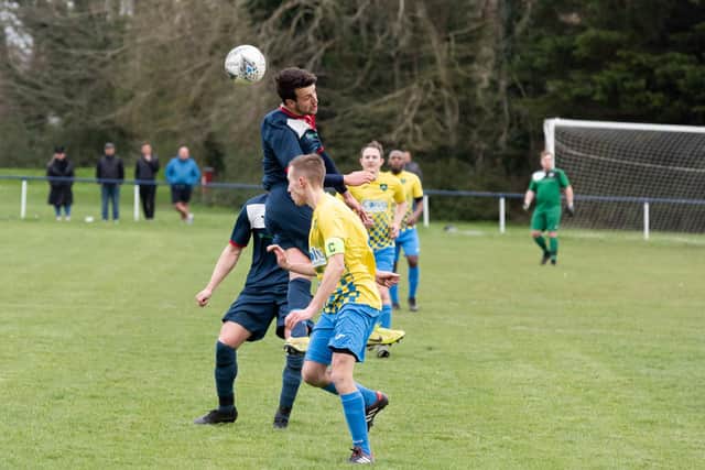 Paulsgrove's Preston Tee rises for a header against Lyndhurst. Picture: Duncan Shepherd