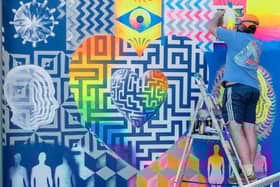 Mark Kellet, a lecturer at Havant & South Downs College, puts the finishing touches on a mural created with a group of LGBTQIA+ youth groups from the college.  Picture: Nuno Cardoso