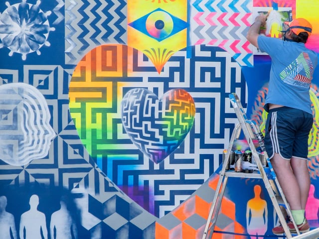 Mark Kellet, a lecturer at Havant & South Downs College, puts the finishing touches on a mural created with a group of LGBTQIA+ youth groups from the college.  Picture: Nuno Cardoso