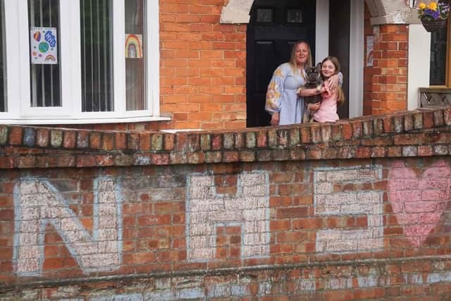 Photographer Sophia Benham from North End has been capturing images of families during lockdown as part of her #atourfrontdoor project to raise money for domestic abuse charity Aurora New Dawn. Pictured: An example of one of the families on their doorstep