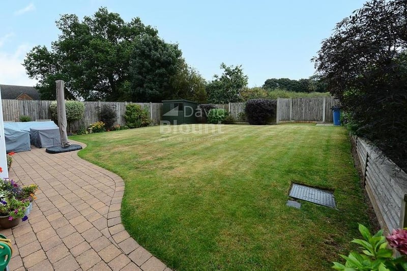Let's take a look outside and inspect the south-facing rear garden. It is mainly laid to lawn, with shrub borders and a paved patio.