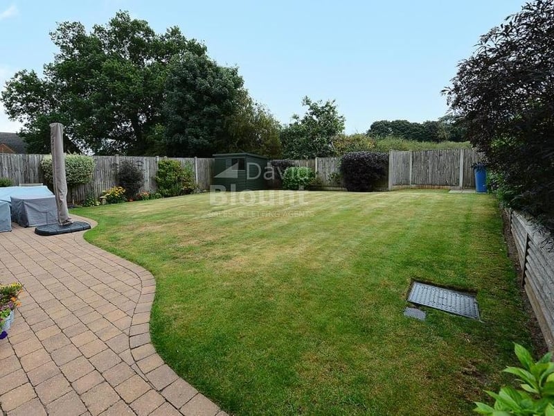 Let's take a look outside and inspect the south-facing rear garden. It is mainly laid to lawn, with shrub borders and a paved patio.