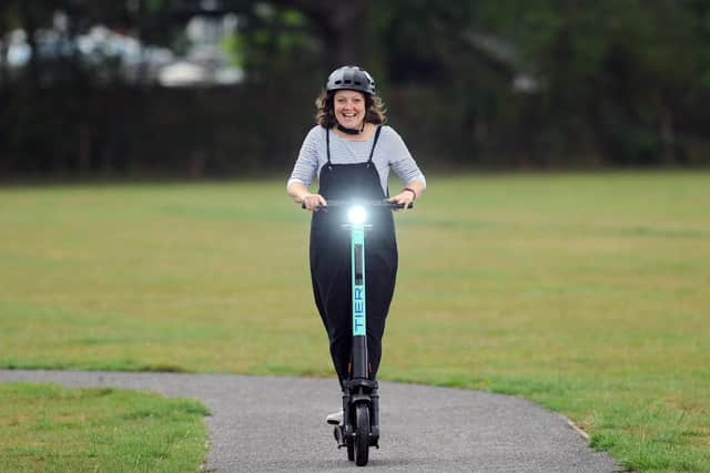 Business editor Kimberley Barber riding an e-scooter from TIER UK