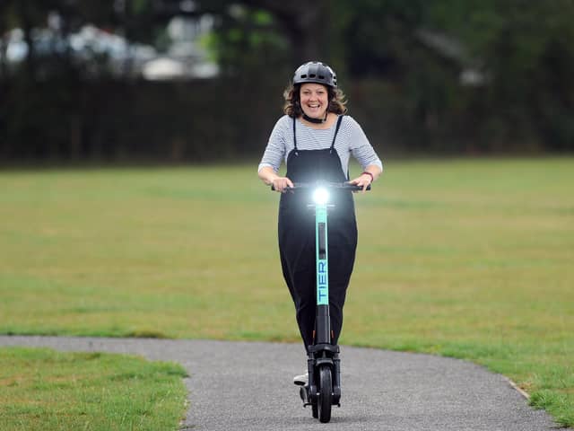 Business editor Kimberley Barber riding an e-scooter from TIER UK
