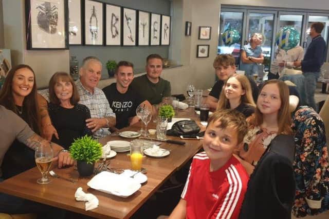 Graham pictured with his grandchildren and wife, Vivien.
