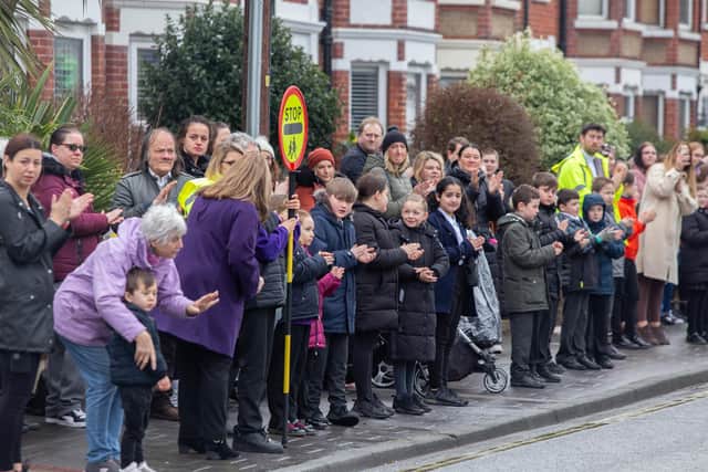 Winter Road/Wimborne Road lollipop man Tom James, who recently passed away, will be honoured by pupils and residents in the areaPictured: Wimborne Primary School watch the hearse carrying Tom James on Winter Road, Portsmouth on Friday 11th March 2022Picture: Habibur Rahman