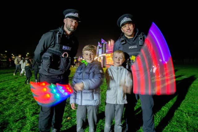 Fireworks at King George V Playing Field, Cosham, Portsmouth on Wednesday 9th November 2022Pictured:  Riley 9 and Jack 7 with Portsmouth Police officersPicture: Habibur Rahman