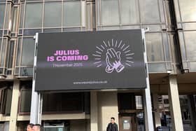 The myterious "Julius is Coming" ad on the big screen at Guildhall Walk.