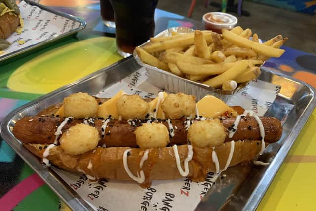 'DD opts for the Tot Dog, a pork frank loaded with ‘Tater Tots’, American cheese, sweet chilli sauce, mayo and sesame seeds. Rustic fries accompany it, which we share. The hotdog arrives quickly, as does my companion’s Speedy Gonzales beef hotdog which comes with crushed tortillas chips, Jalapenos and mild tomato sauce.'