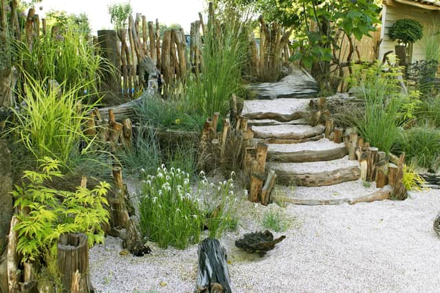 A seaside garden backing on to a sandy beach.