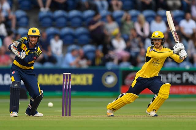 Hampshire's Lewis McManus hits out watched by Chris Cooke during the T20 Blast match against Glamorgan in July 2017. Photo by Stu Forster/Getty Images.