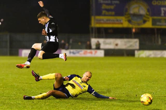 Gosport's Josh Huggins slides in to make a challenge against Dorchester.
Picture: Keith Woodland