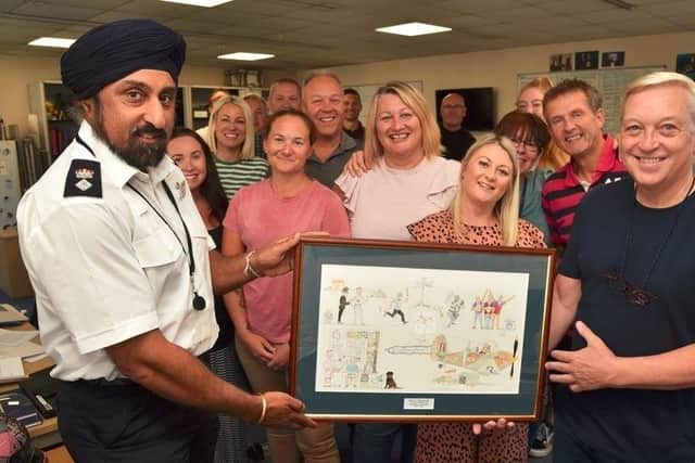 Russell Brumley is presented with the framed picture by Raj Kohli. Picture: Hampshire Constabulary